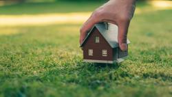 person holding a miniature of a tiny house