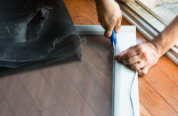 man replacing old, dripped screen door